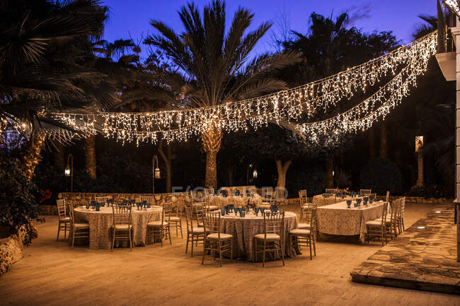 Outdoors restaurant with served tables prepared for dining in the evening — Stock Photo