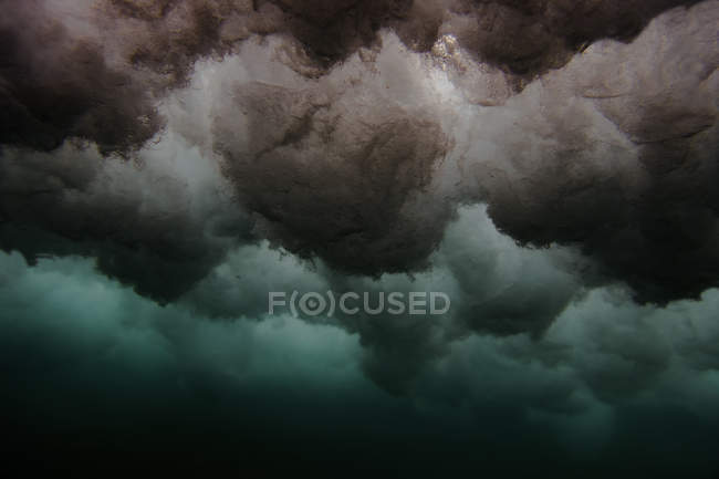 Снизу видны брызги в голубой воде океана — стоковое фото