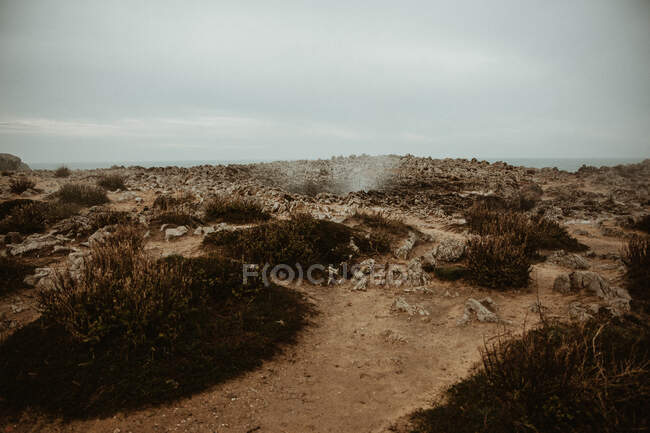 Little crater with smoke between ground and cloudy heaven in Bufones de Pria, Asturias, Spain — Stock Photo