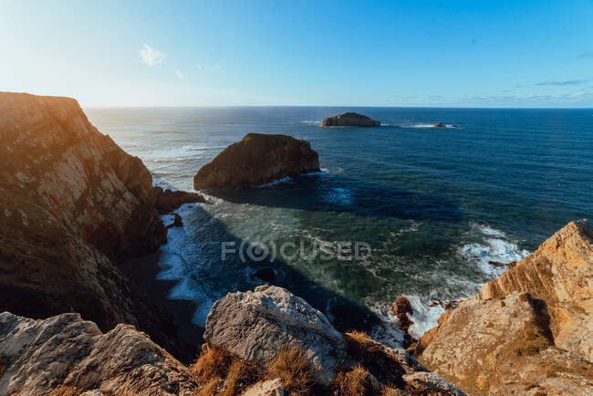 Picturesque view of stone hill near sea in sunny day in Cabo de Penas, Asturias, Spain — Stock Photo