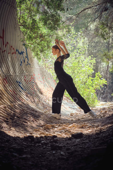 Young ballerina dancing in forest — Stock Photo