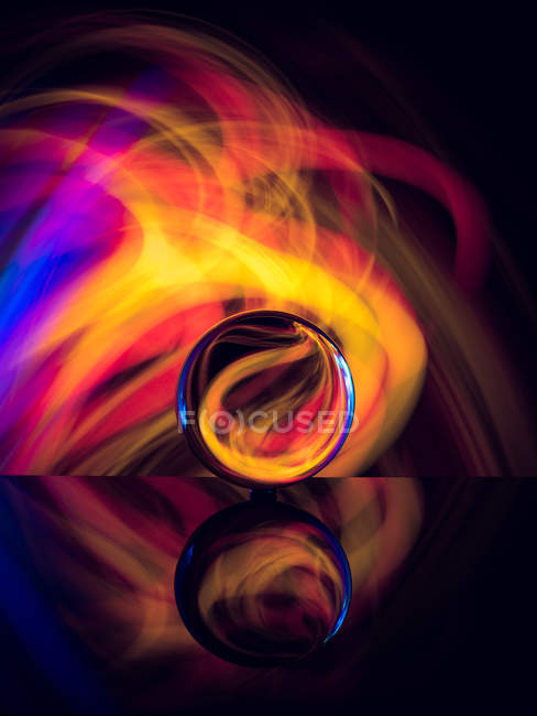 Bola de cristal na superfície com reflexão perto de brilhos abstratos — Fotografia de Stock