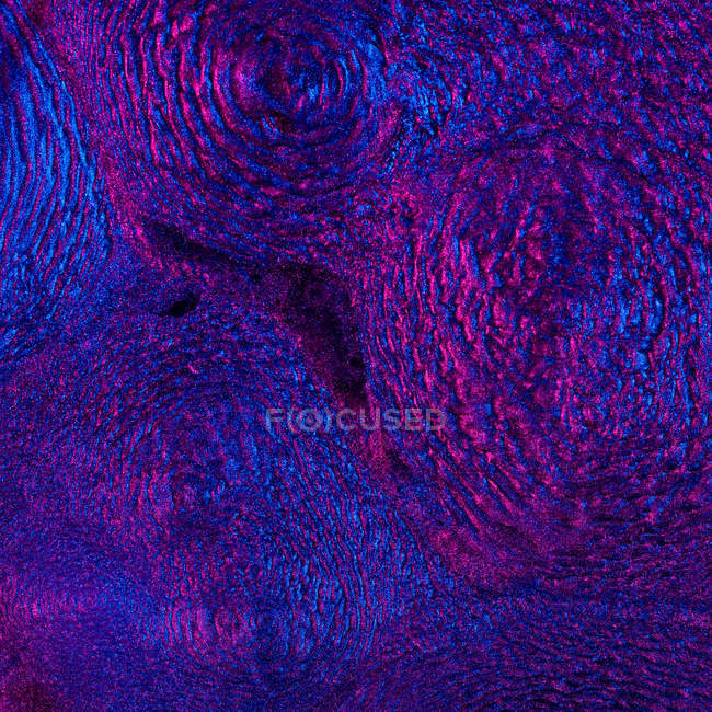 Closeup of ferrofluid illuminated with neon light — Stock Photo
