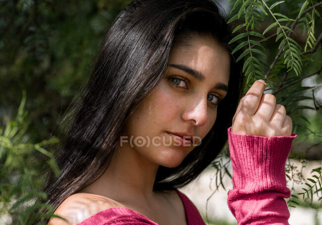 Young charming woman between flowers — Stock Photo