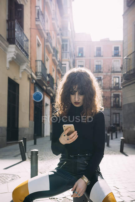 Young woman talking by phone in the street — Stock Photo