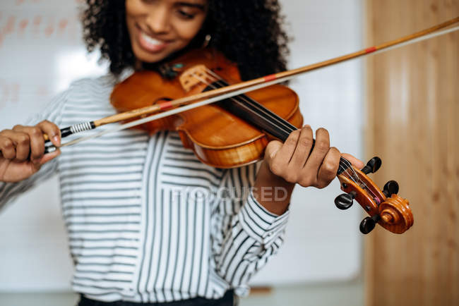 Young woman playing violin with writing board on the background in music  studio — smile, girl - Stock Photo | #255839368