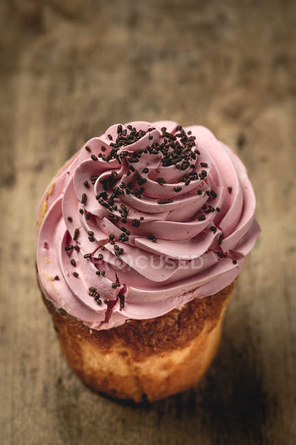 Delicious homemade strawberry cupcake on rustic wooden surface — Stock Photo