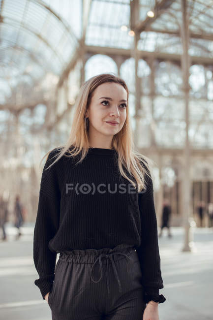 Stylish thoughtful young woman walking in Crystal Palace in Madrid, Spain — Stock Photo