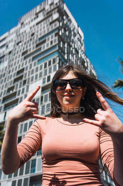 Portrait of 16 year old girl making funny gestures in the street — Stock Photo