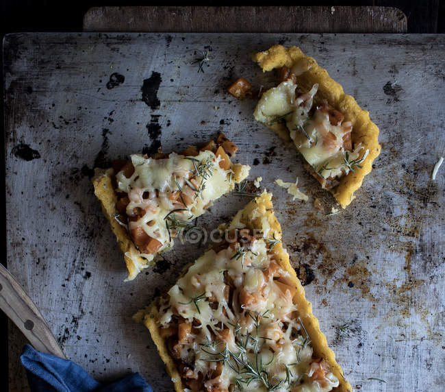 Homemade tart with pumpkin and Emmental cheese on shabby tray on wooden table — Stock Photo