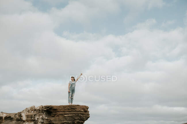 Anonymous female standing of stony terrain — Stock Photo