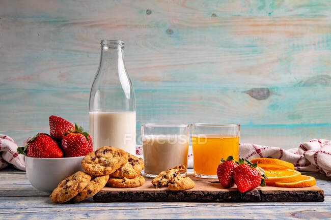 Glasses near fruits and cookies on table near napkin — Stock Photo