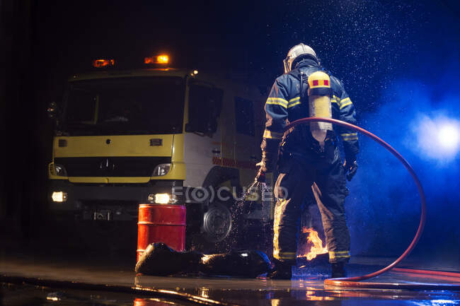 Muscular firefighter on mission — Stock Photo