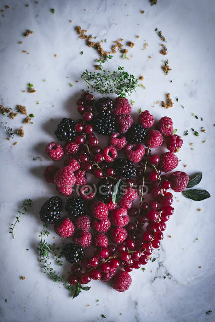 Heap of fresh summer berries on white marble surface — Stock Photo