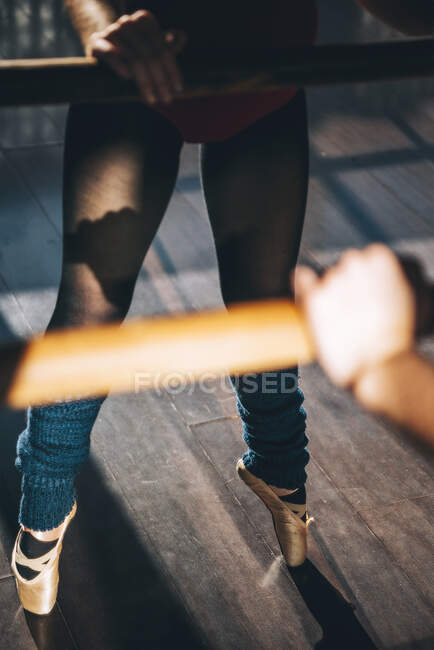 Crop shot of professional dancer in pointe shoes standing on tiptoes in studio. — Stock Photo