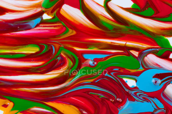 Multicolored brush strokes of acrylic colors on white canvas — Stock Photo