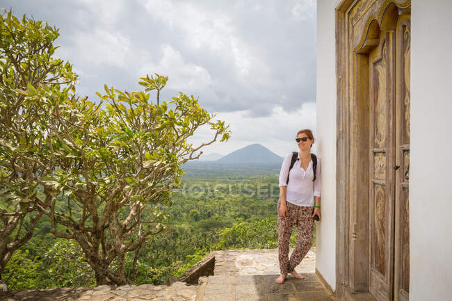Woman leaning on old temple — Stock Photo