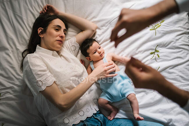 Mãe e bebê deitados na cama — Fotografia de Stock