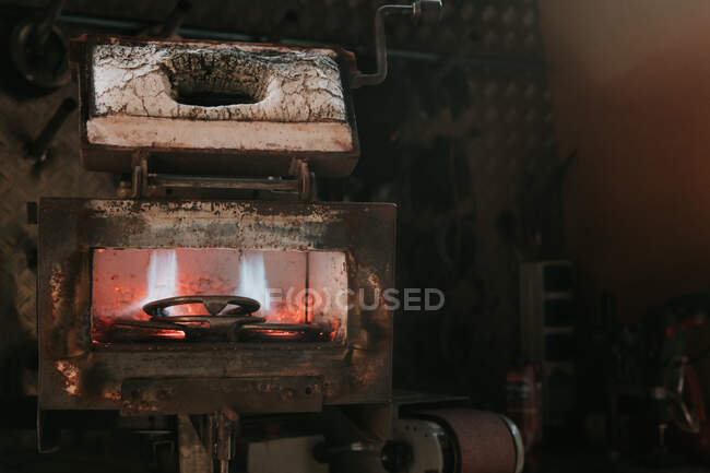 Metal for horseshoes smelting in hot furnace in blacksmith workshop on ranch — Stock Photo