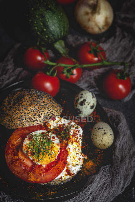 Healthy homemade vegetable sandwich on dark fabric with ingredients — Stock Photo