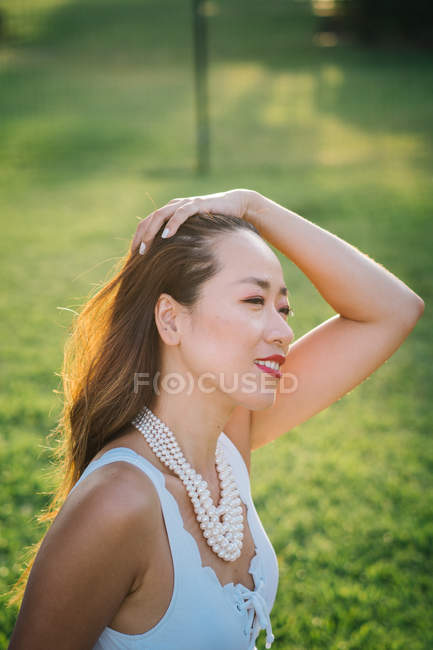 Portrait of a young classy chinese woman against nature background — Stock Photo