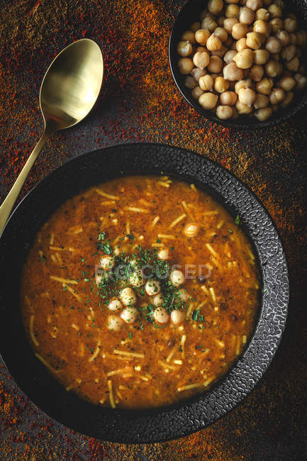 Traditional Harira soup for Ramadan in black bowl on dark background — Stock Photo