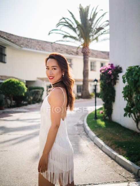 Young trendy chinese woman enjoying holidays at a luxurious resort — Stock Photo