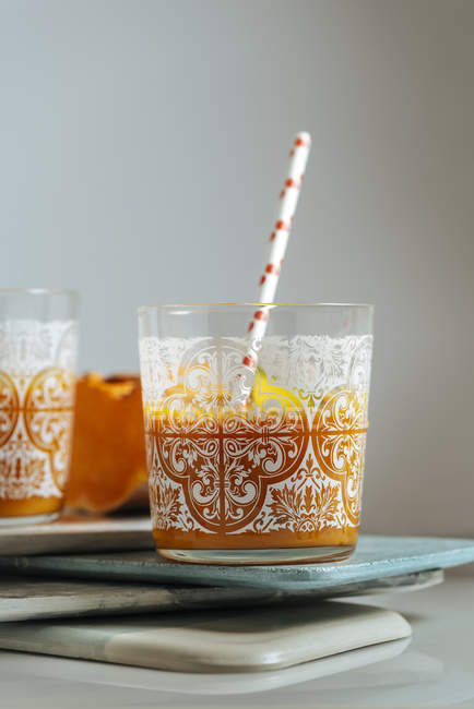 Mango e pompaggio frullato in bicchieri su tavole impilate — Foto stock