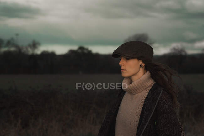 Young woman in warm clothes in forest — Stock Photo