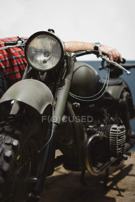 Motor fijo masculino anónimo de moto del ejército - foto de stock