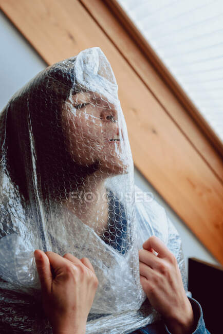 Donna spaventata cercando di liberarsi mentre impigliato in involucro di bolla — Foto stock