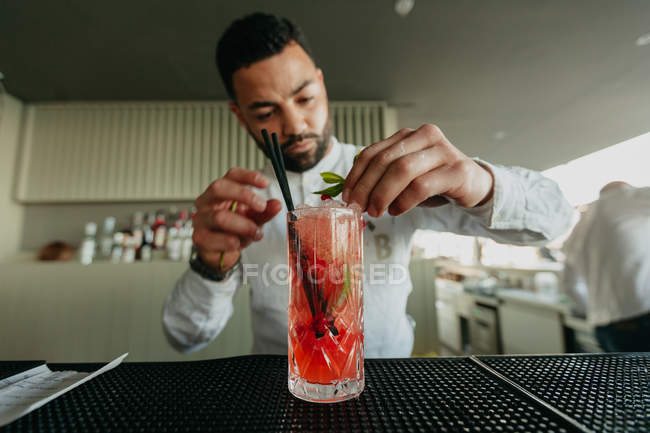 Barman prepara bebida alcoólica em bar — Fotografia de Stock