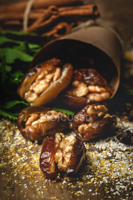 Halal snack for Ramadan with dried dates, figs, fresh mint and cinnamon wrapped in parchment — Stock Photo
