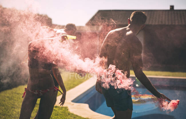 Friends lighting smoke torch — Stock Photo
