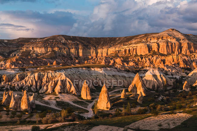 Rough stone formations in valley on sunny day in Cappadocia, Turkey — Stock Photo