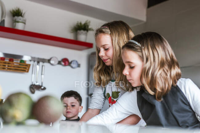 Little girls and boy Kids playing while while cooking healthy salad in kitchen together — Stock Photo