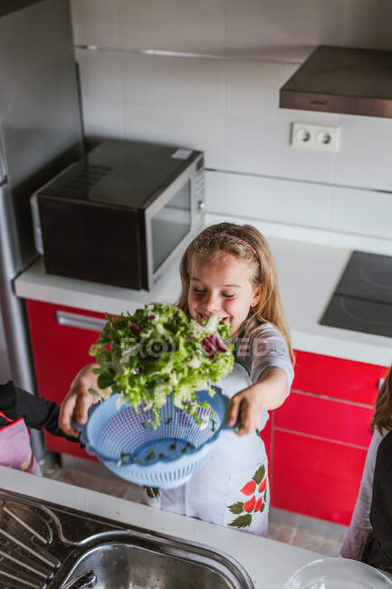 Little girls and boy Kids playing while while cooking healthy salad in kitchen together — Stock Photo