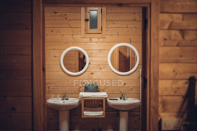 Bathroom in wooden house with opened door — Stock Photo
