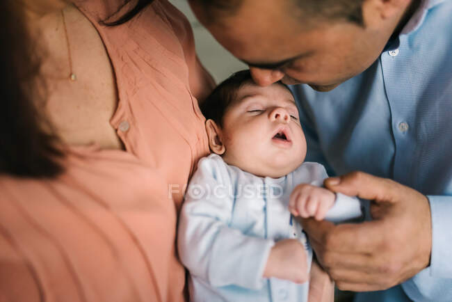 Glückliche junge Mutter mit Neugeborenem und Vater zu Hause — Stockfoto
