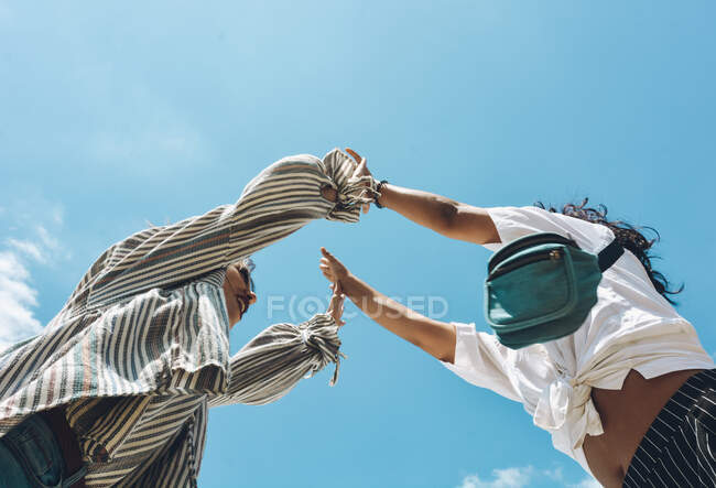 Group of friends embraced and putting their hands together. All of them very happy and showing happiness — Stock Photo