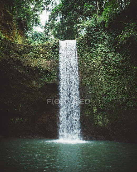 Clear water of lake with waterfall on background, Bali — Stock Photo