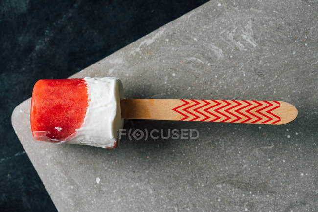 Closeup of watermelon and cream popsicle on dark background — Stock Photo