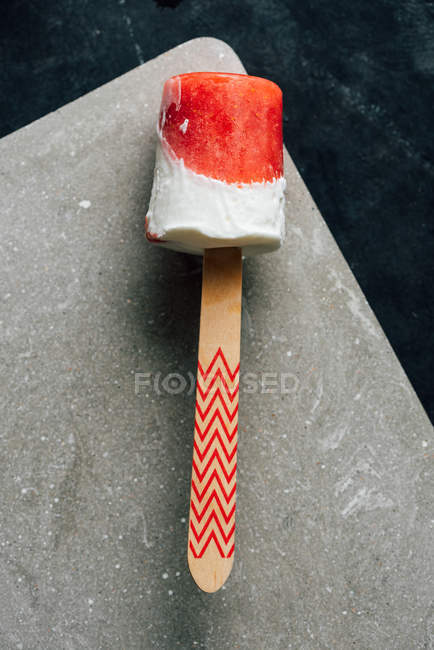 Closeup of watermelon and cream popsicle on grey board — Stock Photo