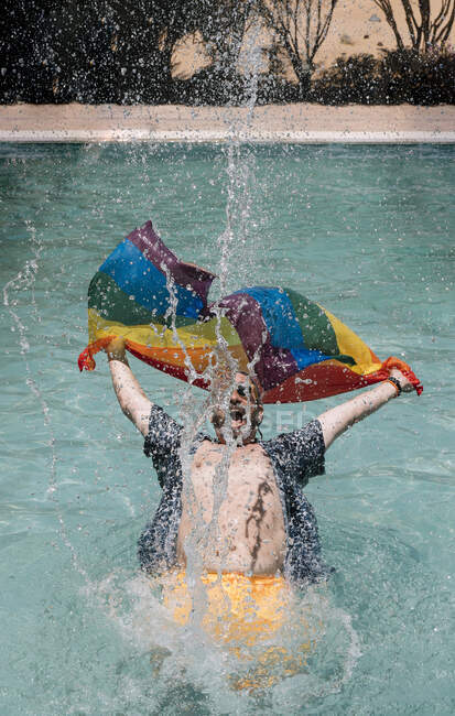 Excited gay in swimming pool — Stock Photo
