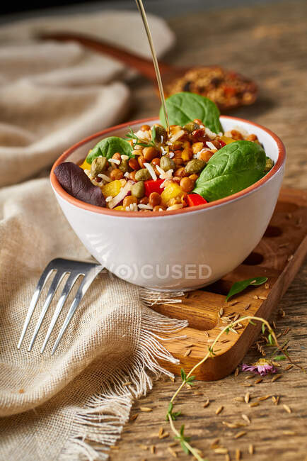 From above appetizing colorful cut vegetable mix with spinach lentils and rice on wooden background — Stock Photo