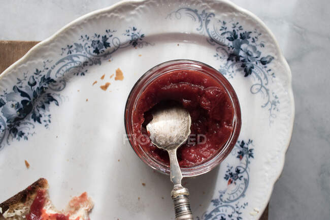 Top view of plate with bread toast and butter and strawberry marmalade served on vintage plate — Stock Photo