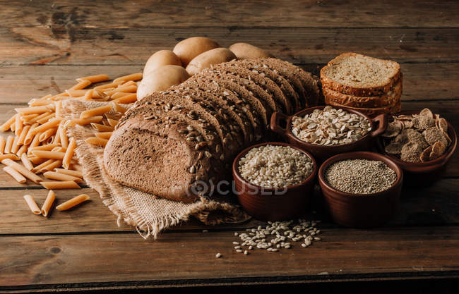 Свіжоспечений нарізаний житній хліб на серветці на дерев'яному столі — стокове фото