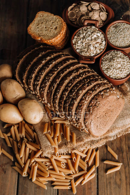 Freshly baked sliced rye bread on napkin on wooden table — Stock Photo