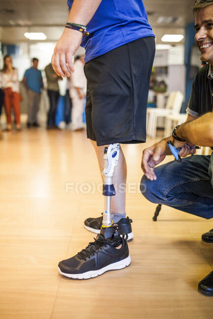 Prosthetic engineer reviewing the prosthesis of a patient and improving the material in his workshop — Stock Photo