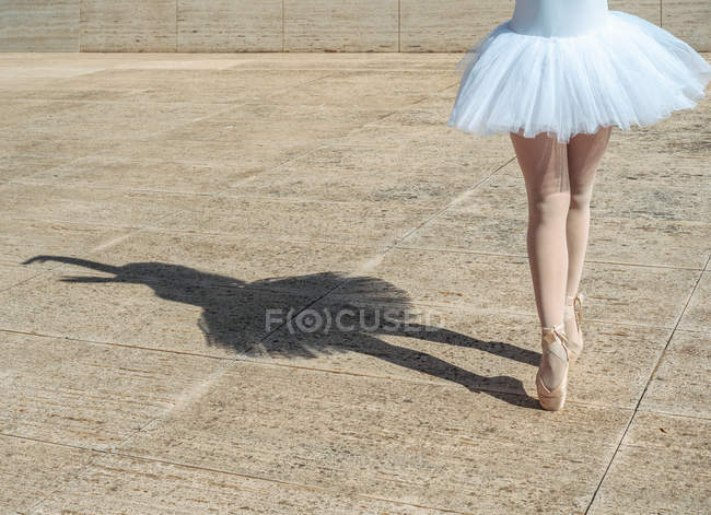 Legs of ballerina standing on tiptoe classical position outside — Stock Photo
